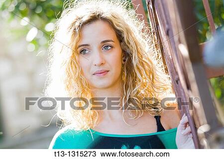 Stock Image - Daydreaming young blonde woman portrait. Fotosearch