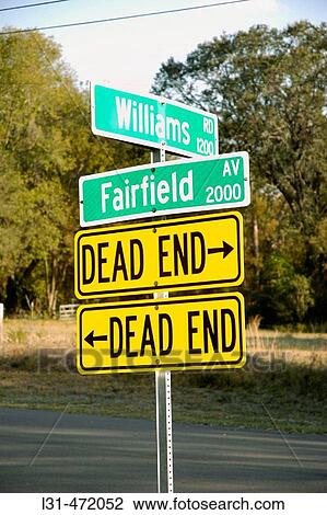 Stock Image - Dead End signs pointing both ways to Dead End of streets in Florida. USA.. Fotosearch