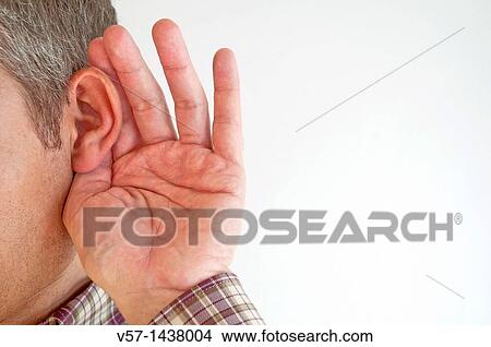 Picture - Deaf man holding his hand behind his ear to amplify sound. Close view.. Fotosearch