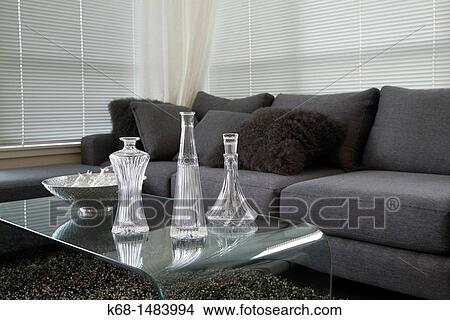 decanters on a table by a sofa in a living room View Large Photo Image Picture - decanters on a table by a sofa in a living room. Fotosearch