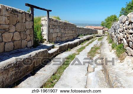 Deep rut in the road, Cufut Qale, Chufut-Kale Jewish Fortress Crimea, Ukraine, Eastern Europe. View Large Photo Image Stock Photo - Deep rut in the road, Cufut Qale, Chufut-Kale Jewish Fortress Crimea, Ukraine, Eastern Europe.. Fotosearch