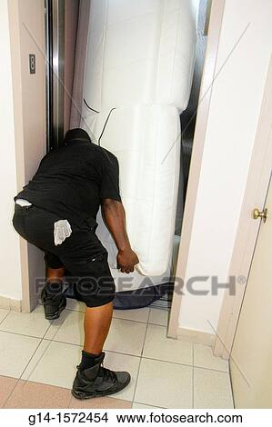 Deliveryman carrying sofa View Large Photo Image Picture - Deliveryman carrying sofa. Fotosearch