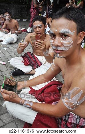 Denpasar (Bali, Indonesia): Balinese adolescents putting on facial paintings at the Bali Arts Festival opening View Large Photo Image Stock Photograph - Denpasar (Bali, Indonesia): Balinese adolescents putting on facial paintings at the Bali Arts Festival opening. Fotosearch