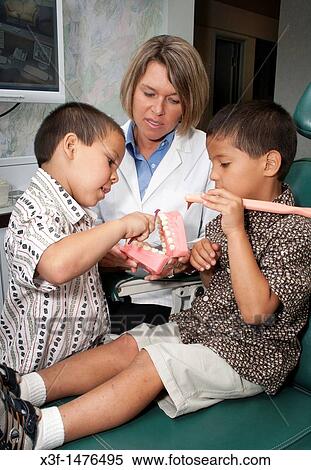 Dental hygienist helping patients brush teeth correctly St Paul Minnesota MN USA View Large Photo Image Stock Photography - Dental hygienist helping patients brush teeth correctly St Paul Minnesota MN USA. Fotosearch