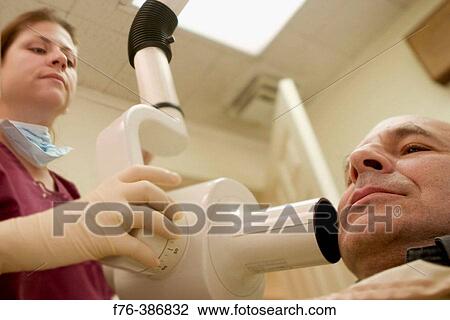 Dental hygienist x-raying teeth View Large Photo Image Stock Image - Dental hygienist x-raying teeth. Fotosearch