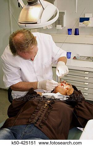Dentist examining patient View Large Photo Image Stock Image - Dentist examining patient. Fotosearch