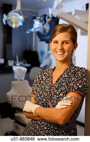 Dentist posing in front of dental facility View Large Photo Image Stock Photo - Dentist posing in front of dental facility. Fotosearch