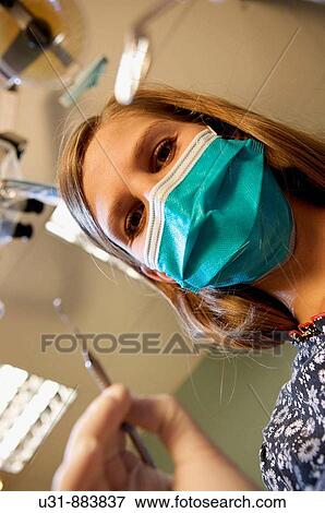 Dentist working on a patient View Large Photo Image Stock Photo - Dentist working on a patient. Fotosearch