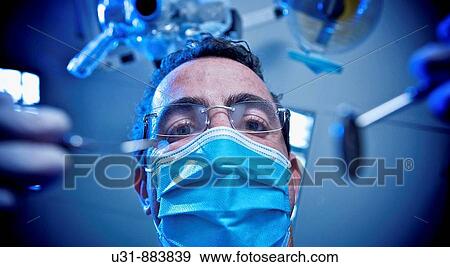 Dentist working on a patient View Large Photo Image Stock Photo - Dentist working on a patient. Fotosearch