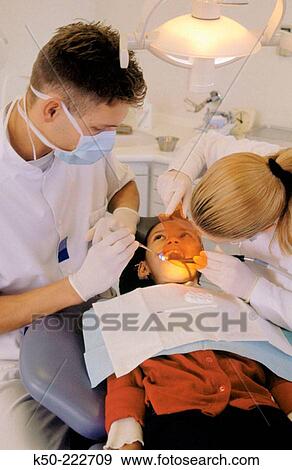 Dentists with patient View Large Photo Image Stock Photo - Dentists with patient. Fotosearch