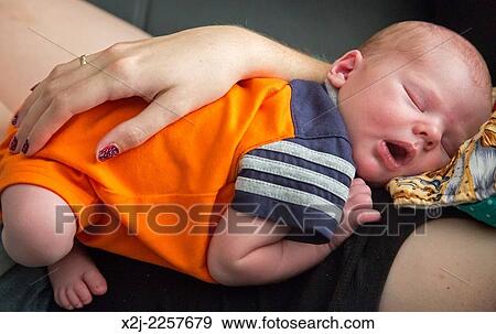 Stock Photo - Denver, Colorado - Mariel West holds her week-old son, Adam Hjermstad Jr.. Fotosearch