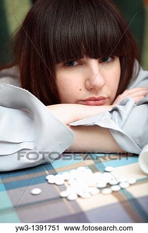 depression - women and drags open pack of pills on the table View Large Photo Image Stock Image - depression - women and drags open pack of pills on the table. Fotosearch