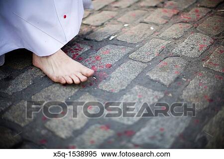 Detail of a barefoot penitent walking on the pavement with melted wax drops, Holy Week 2008, Seville, Spain View Large Photo Image Stock Photography - Detail of a barefoot penitent walking on the pavement with melted wax drops, Holy Week 2008, Seville, Spain. Fotosearch