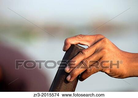 Detail of a fisherman's hand at work on the Mekong River early in the morning outside of Phnom Penh, Cambodia. View Large Photo Image Picture - Detail of a fisherman's hand at work on the Mekong River early in the morning outside of Phnom Penh, Cambodia.. Fotosearch