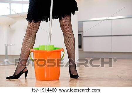 Detail of a sexy young woman mopping the kitchen in high heels and rubber gloves View Large Photo Image Stock Image - Detail of a sexy young woman mopping the kitchen in high heels and rubber gloves. Fotosearch