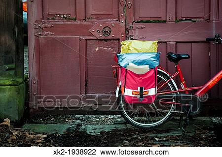 Stock Image - Detail of envelopes and red bike of royal mail, Liverpool, UK. Fotosearch