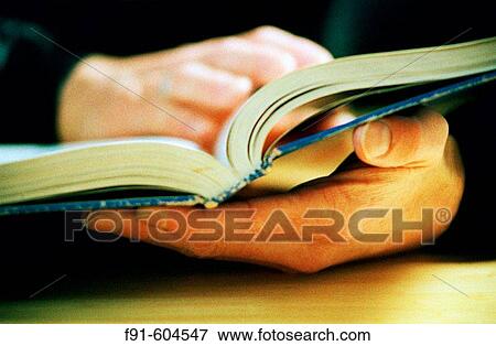 Detail of hands holding textbook View Large Photo Image Stock Photo - Detail of hands holding textbook. Fotosearch