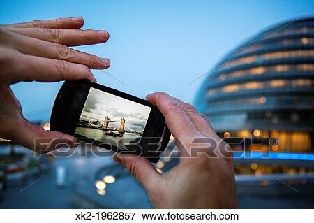 Detail of hands Taking a picture of Tower Bridge with a mobile phone, London, UK View Large Photo Image Stock Photo - Detail of hands Taking a picture of Tower Bridge with a mobile phone, London, UK. Fotosearch