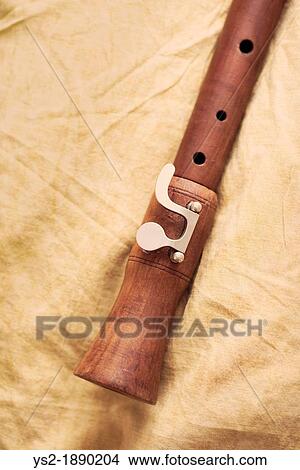 Detail of music instrument, wood flute lying on textile View Large Photo Image Picture - Detail of music instrument, wood flute lying on textile. Fotosearch