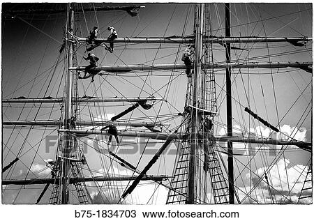 Detail of sailors working on the masts of a vintage yacht, View Large Photo Image Stock Image - Detail of sailors working on the masts of a vintage yacht,. Fotosearch