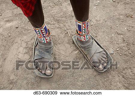 Detail of sandals made from car tires and ankle ornaments worn by a Masai warrior, Masai village within the Amboseli National Park. Kenya View Large Photo Image Stock Photo - Detail of sandals made from car tires and ankle ornaments worn by a Masai warrior, Masai village within the Amboseli National Park. Kenya. Fotosearch