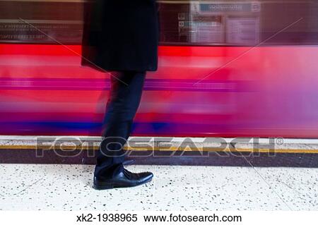 Detail of shoes and legs of a smart man waiting in the London overground DLR Canary wharf station, London, UK View Large Photo Image Stock Photography - Detail of shoes and legs of a smart man waiting in the London overground DLR Canary wharf station, London, UK. Fotosearch