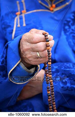 Detail of the hand holding a rosary, Mongolia View Large Photo Image Stock Image - Detail of the hand holding a rosary, Mongolia. Fotosearch