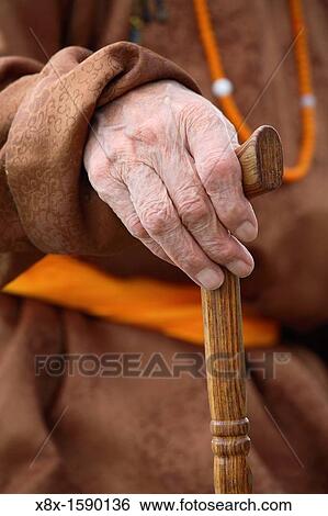 Detail of the hand holding a walking stick, Mongolia View Large Photo Image Stock Photograph - Detail of the hand holding a walking stick, Mongolia. Fotosearch
