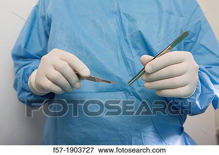 Detail of Veterinarian holding medical equipment View Large Photo Image Stock Photo - Detail of Veterinarian holding medical equipment. Fotosearch