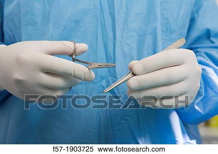 Detail of Veterinarian holding medical equipment View Large Photo Image Stock Photography - Detail of Veterinarian holding medical equipment. Fotosearch
