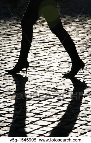 Stock Photography - detail of woman walking in street road city town. Fotosearch