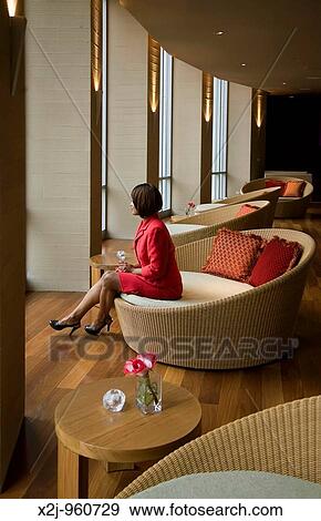 Detroit, Michigan - A woman waits by windows in a nightclub lounge called Ignite at the MGM Grand casino View Large Photo Image Stock Photo - Detroit, Michigan - A woman waits by windows in a nightclub lounge called Ignite at the MGM Grand casino. Fotosearch