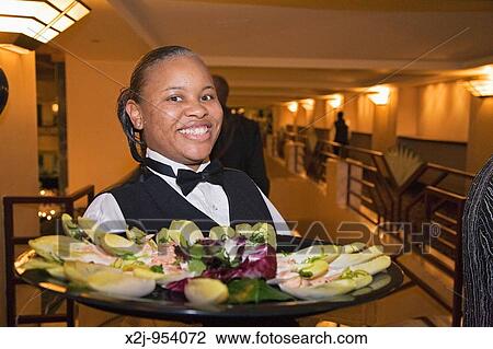 Detroit, Michigan - A worker at the Atheneum Hotel serves hors d? oeuvres to guests at a party celebrating a Bar Mitzvah View Large Photo Image Stock Image - Detroit, Michigan - A worker at the Atheneum Hotel serves hors d? oeuvres to guests at a party celebrating a Bar Mitzvah. Fotosearch