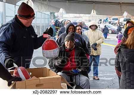 Stock Photo - Detroit, Michigan - Detroit residents lined up for one of 600 free Thanksgiving turkeys donated by a local company, Inland Waters Pollution Control.. Fotosearch