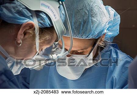 Detroit, Michigan - Dr. Shelly Seward (right) and Dr. Stephanie Munns perform a hysterectomy on a woman with endometrial cancer at Karmanos Cancer Institute. View Large Photo Image Stock Image - Detroit, Michigan - Dr. Shelly Seward (right) and Dr. Stephanie Munns perform a hysterectomy on a woman with endometrial cancer at Karmanos Cancer Institute.. Fotosearch