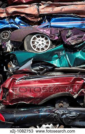 Stock Image - Detroit, Michigan - Junk cars crushed and ready for recycling at a scrap yard. Fotosearch