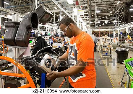 Detroit, Michigan - Members of the United Auto Workers union build dashboards for Ford vehicles at Detroit Manufacturing Systems. View Large Photo Image Picture - Detroit, Michigan - Members of the United Auto Workers union build dashboards for Ford vehicles at Detroit Manufacturing Systems.. Fotosearch