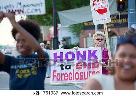 Detroit, Michigan - Neighbors hold a vigil on a street corner outside Jennifer Britt's home, hoping to block the planned eviction of her family View Large Photo Image Stock Photo - Detroit, Michigan - Neighbors hold a vigil on a street corner outside Jennifer Britt's home, hoping to block the planned eviction of her family. Fotosearch