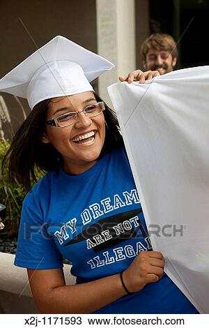 Detroit, Michigan - On the day it was to go into effect, people protest Arizona's new immigration law outside the federal building Students wearing mortarboards urged passage of the DREAM Act, which would grant legal status to students who were brought t View Large Photo Image Stock Image - Detroit, Michigan - On the day it was to go into effect, people protest Arizona's new immigration law outside the federal building Students wearing mortarboards urged passage of the DREAM Act, which would grant legal status to students who were brought t. Fotosearch