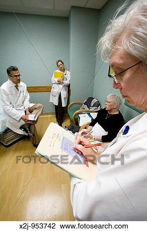 Detroit, Michigan - Research nurse Susan Newell takes notes as Dr Robert Morris and nurse practitioner talk to ovarian cancer patient Pat Lancaster View Large Photo Image Stock Image - Detroit, Michigan - Research nurse Susan Newell takes notes as Dr Robert Morris and nurse practitioner talk to ovarian cancer patient Pat Lancaster. Fotosearch