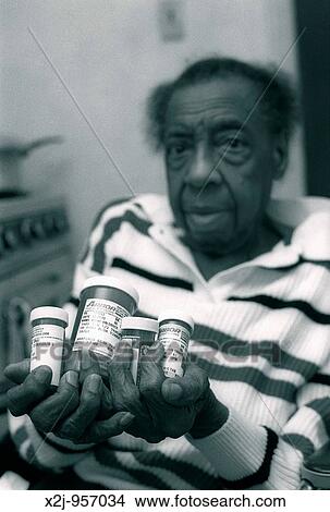 Detroit, Michigan - Wilhelmina Driver holds the prescription drugs that she takes every day View Large Photo Image Picture - Detroit, Michigan - Wilhelmina Driver holds the prescription drugs that she takes every day. Fotosearch