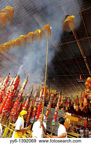Stock Photo - Devotees hang incense swirls and ceremonial lanterns high among the rafters, Vegetarian festival at San Jao Sieng Kong shrine, wat sung heng yee, Chinatown, Bangkok. Fotosearch