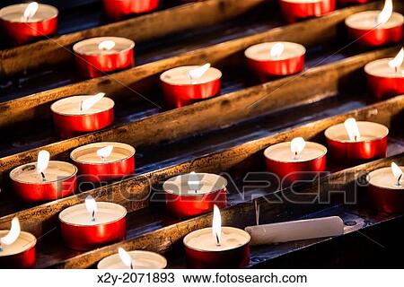 Devotional prayer candles in a Catholic church. View Large Photo Image Stock Image - Devotional prayer candles in a Catholic church.. Fotosearch