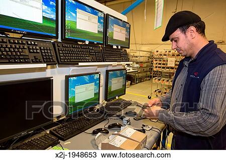 Stock Image - Dexter, Michigan - Cell phone recycling at ReCellular, Inc. The company collects used phones, inspects and repairs them, and resells them. Some of the work is done for charities, which collect used phones and profit from the re-sales.. Fotosearch