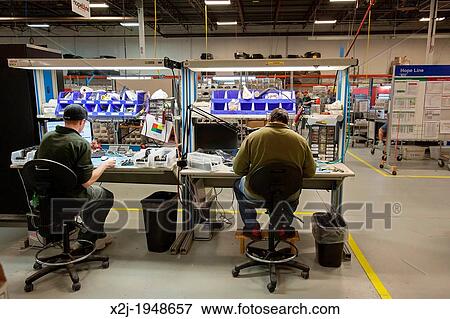 Stock Photo - Dexter, Michigan - Cell phone recycling at ReCellular, Inc. The company collects used phones, inspects and repairs them, and resells them. Some of the work is done for charities, which collect used phones and profit from the re-sales.. Fotosearch