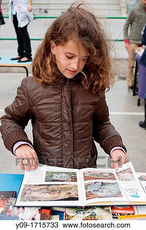 Diada de Sant Jordi, Girl in the book stall, Barcelona, Catalonia, Spain View Large Photo Image Stock Image - Diada de Sant Jordi, Girl in the book stall, Barcelona, Catalonia, Spain. Fotosearch