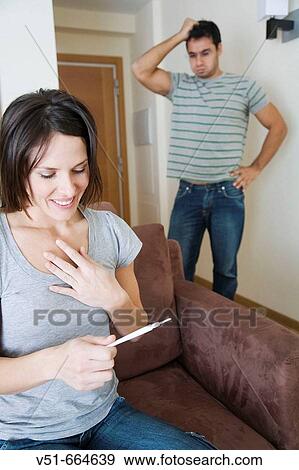 Stock Photo - Different reactions in a couple after a pregnancy test.. Fotosearch