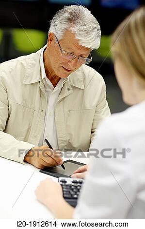 Picture - Digital signature, Reception of patients, Onkologikoa Hospital, Oncology Institute, Case Center for prevention, diagnosis and treatment of cancer, Donostia, San Sebastian, Gipuzkoa, Basque Country, Spain. Fotosearch