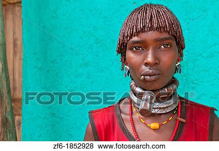 Dimeka Ethiopia Africa village Lower Omo Valley portrait of attractive Hamar woman with necklace showing First Wife against green wall 19 View Large Photo Image Stock Photo - Dimeka Ethiopia Africa village Lower Omo Valley portrait of attractive Hamar woman with necklace showing First Wife against green wall 19. Fotosearch
