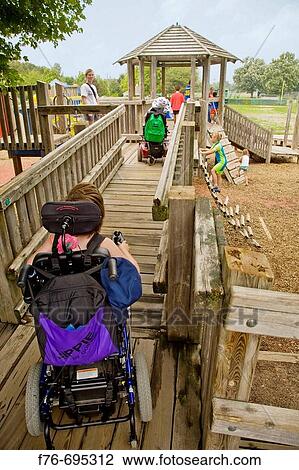 Disabled children in wheelchairs playing on a specially constructed playground structure with access ramp with able bodied children View Large Photo Image Stock Image - Disabled children in wheelchairs playing on a specially constructed playground structure with access ramp with able bodied children. Fotosearch
